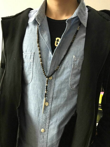 GRENZELOZE BESCHERMING BRONZIET EN ZWARTE ONYX KETTING