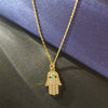 OVERVLOEDIGE VOORSPOED TURQUOISE & GOUDEN HAMSA HANDKETTING